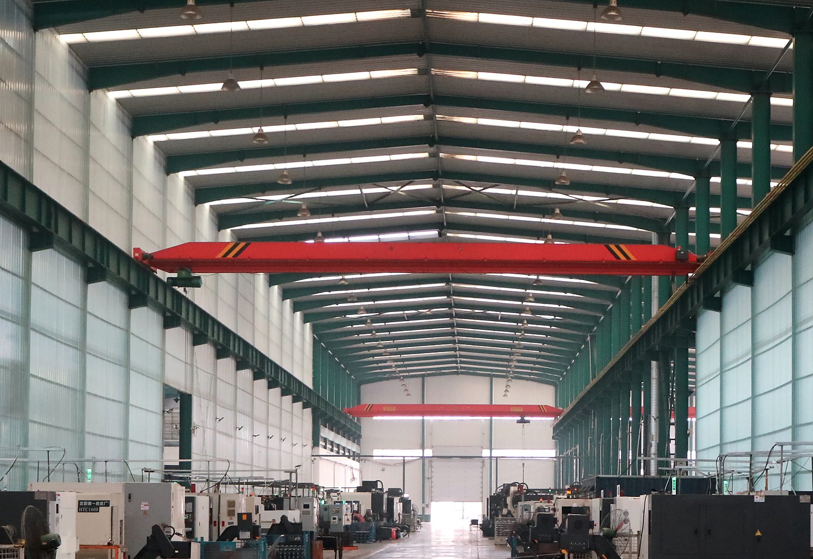 The machining bay at Ludon Forge, CNC lathes running down both sides of the aisle.